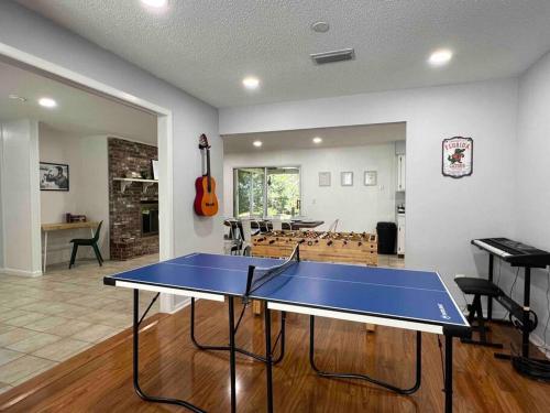 a ping pong table in the middle of a room at Gator Haven in Gainesville