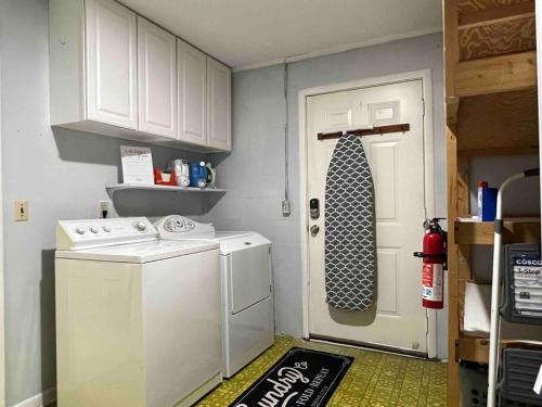 a white door with a tie next to a washing machine at Gator Haven in Gainesville