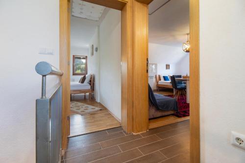 a hallway with a door leading to a living room at Apartmani Jelenača in Sinanovići
