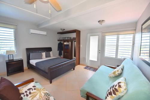 a bedroom with a bed and a couch at Luxury Villa Bonita Sleep 50 + in Isabela