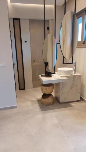 a bathroom with a sink and a mirror at Niriides Palace in Gournes