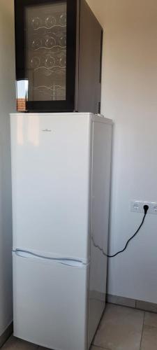a white refrigerator with a chalkboard on top of it at Ferienwohnung Stoisser in Mureck