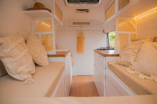 an interior of an rv with a bench and a counter at Campervan Bogota Rolling Suite in Bogotá