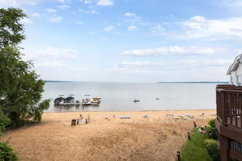 a view of a beach with boats in the water at Beach 321 with Vaulted Ceilings Pool Hot Tub and Stunning Views from Private Deck in Traverse City