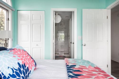 a bedroom with blue walls and a bed with a pillow at Beach 321 with Vaulted Ceilings Pool Hot Tub and Stunning Views from Private Deck in Traverse City