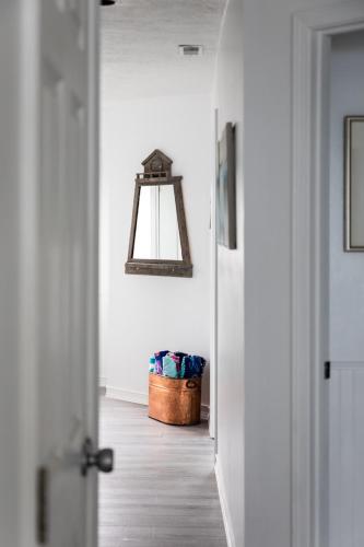 a hallway with a door and a basket in a room at Beach 321 with Vaulted Ceilings Pool Hot Tub and Stunning Views from Private Deck in Traverse City