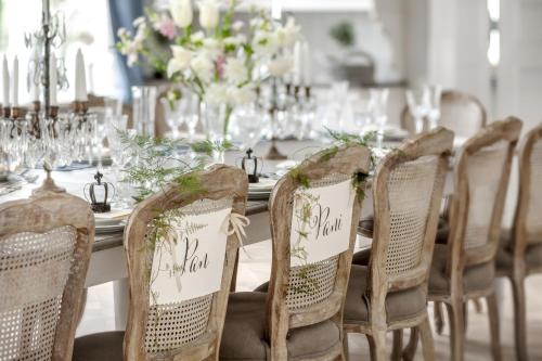 a table with chairs and a table with flowers at Pałac Kamieniec in Polanica-Zdrój