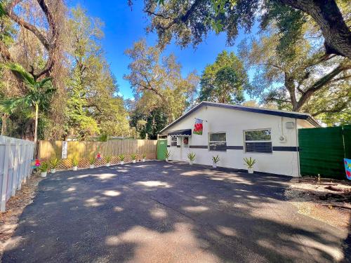 a white garage with a fence and a driveway at The Boutique Guest House in Miami
