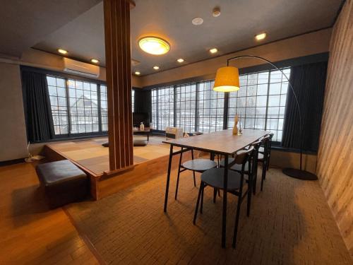 a dining room with a table and chairs and a living room at Kawamura Building 3F - Vacation STAY 47042v in Kusatsu