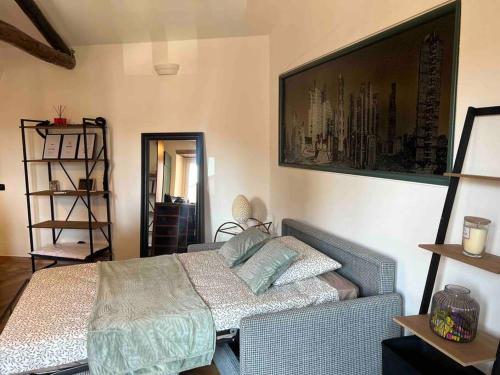 a bedroom with a bed and a picture on the wall at Kiko's Lodge - Historical Apartment in Como in Como