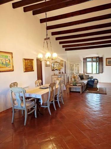 a living room with a dining table and chairs at Mas Fina in Palafrugell