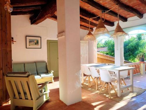 a dining room with a table and chairs in a house at Mas Fina in Palafrugell