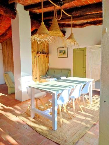 a white table and chairs in a room with a table and chairs at Mas Fina in Palafrugell
