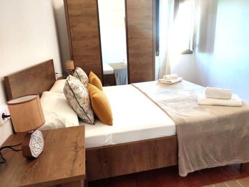 a bedroom with a large bed with a wooden headboard at Mas Fina in Palafrugell