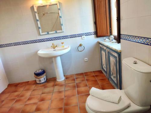 a bathroom with a white sink and a toilet at Mas Fina in Palafrugell