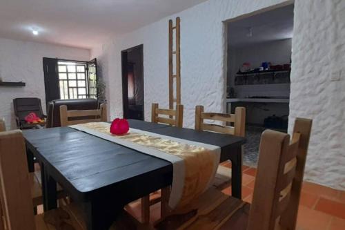 a dining room with a black table and chairs at Casatoca House Zapatoca Lengerke in Zapatoca