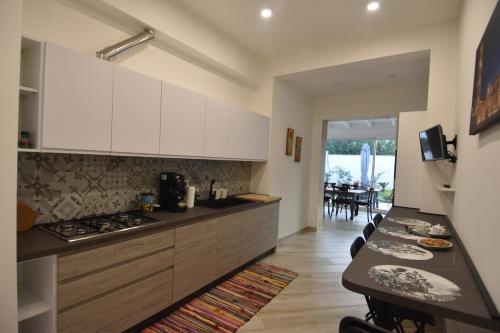 a kitchen with white cabinets and a counter top at Casa Romeo in Lecce
