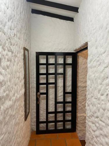 a door in a room with a white wall at Casatoca House Zapatoca Lengerke in Zapatoca