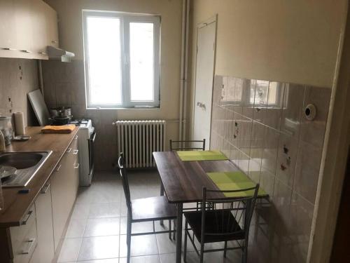 a kitchen with a table and chairs and a sink at Amazing Apartments in Bucharest