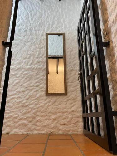 a mirror on a wall next to a door at Casatoca House Zapatoca Lengerke in Zapatoca