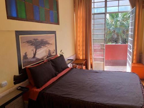 a bedroom with a large bed and a window at Hostal Huacachina Sunset in Ica
