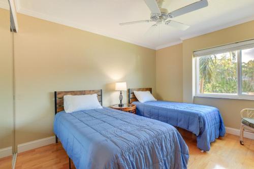 two beds in a bedroom with a ceiling fan at Welcoming Sarasota Vacation Rental with Pool! in Sarasota