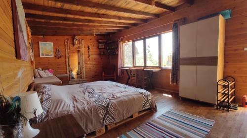 a bedroom with a bed in a wooden cabin at Ovadi Valley Houses in Urgup