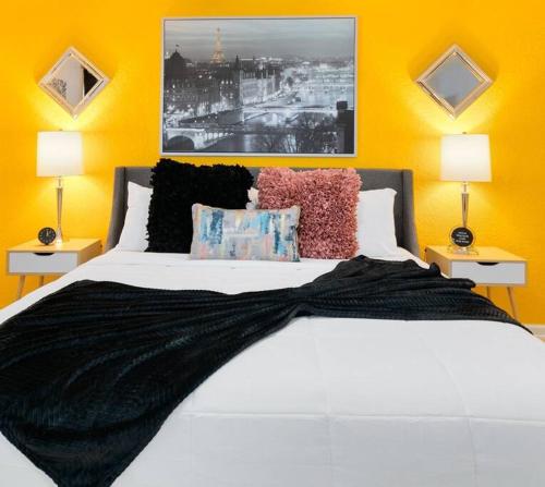 a bedroom with a large white bed with two lamps at Ocean 25 - Waveside in Indian Harbour Beach