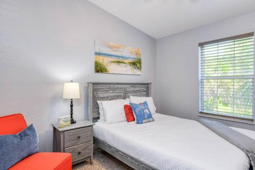 a bedroom with two beds and a window at 102 10th St. in Saint Augustine Beach