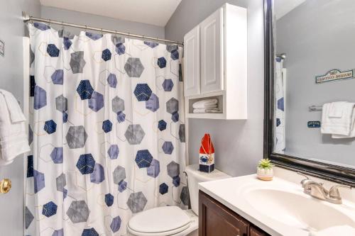 a bathroom with a toilet sink and a shower curtain at 102 10th St. in Saint Augustine Beach