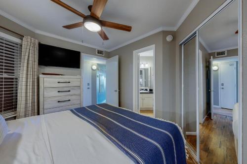 a bedroom with a bed and a ceiling fan at Marvilla Condo My Happy Place in Galveston