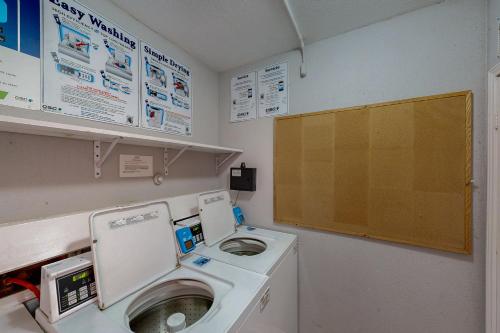 a laundry room with a washing machine and a washer at Marvilla Condo My Happy Place in Galveston