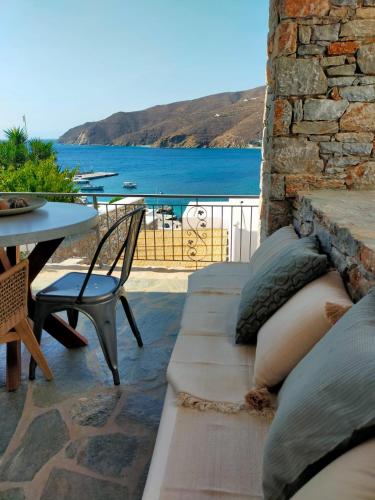 a patio with a table and a view of the water at Amorgos Elegant Houses, 6 Villas in Amorgos