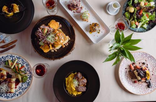 a white table with plates of food on it at BTH Hotel Arequipa Lake in Arequipa