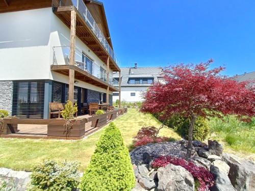 a house with a garden in front of it at SCANDIC Apartments Boží Dar in Boží Dar