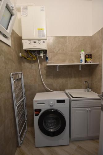 a washing machine in a bathroom with a sink at Casa Romeo in Lecce