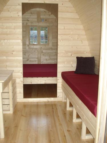 a small room with a bed in a cabin at Vinland Camping Pods in Egilsstaðir