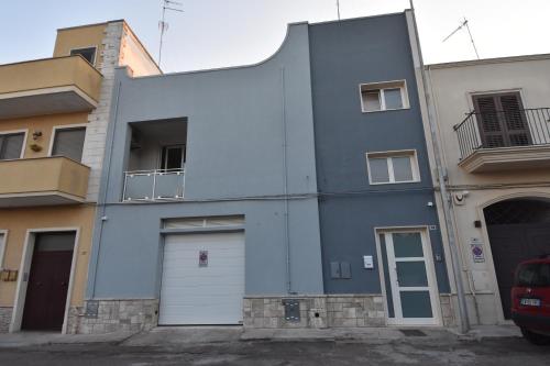 a blue building with two white garage doors at Casa Romeo in Lecce