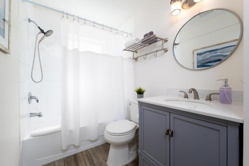 a bathroom with a sink and a toilet and a mirror at NEW Listing! 5 Blocks to the Beach! in Jacksonville Beach