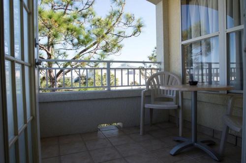 a balcony with a table and chairs and a window at Vacation Village at Parkway in Orlando