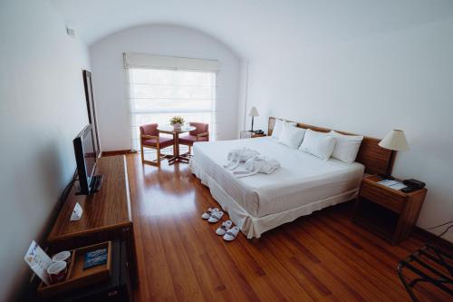 a bedroom with a large bed and a living room at BTH Hotel Arequipa Lake in Arequipa