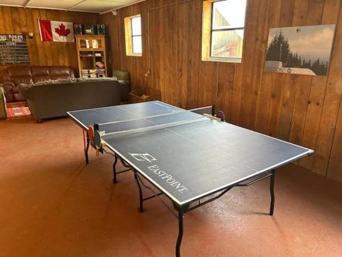 a ping pong table in the middle of a room at Stunning 5-bed Retreat in Sunshine Valley in Sunshine Valley