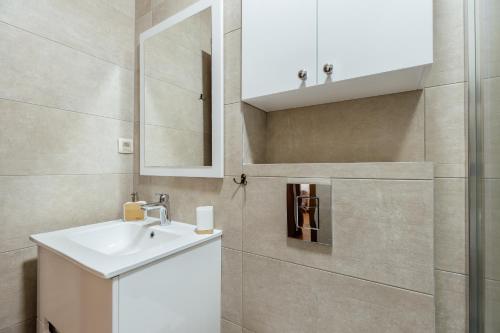 a bathroom with a sink and a mirror at Pool résidence apartment Tivat in Tivat