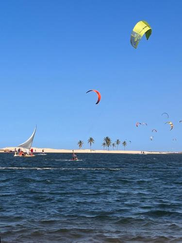 a group of kites flying over a body of water at Eco Paradise 110 - Cumbuco in Caucaia