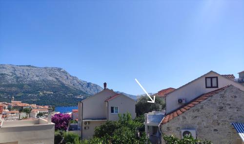 a view of a town with a mountain in the background at Apartments San Antonio in Korčula