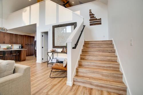 a staircase in a home with white walls and wood floors at Modern Donnelly Cabin with Private Hot Tub in Donnelly