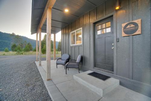 a front porch of a house with two chairs at Modern Donnelly Cabin with Private Hot Tub in Donnelly