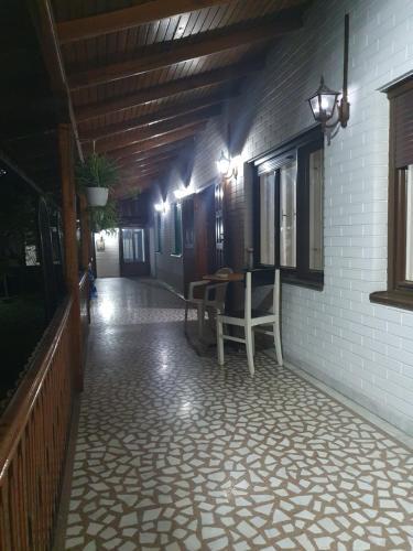 a porch of a house with a table and chairs at Vila Balkan in Kikinda