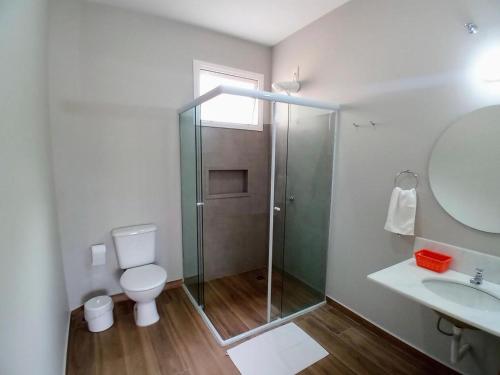 a bathroom with a shower and a toilet and a sink at Kauano Pousada Barequeçaba in São Sebastião