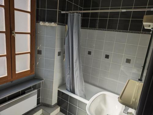 a bathroom with a toilet and a sink and a shower at Résidence les deux Nestes in Arreau